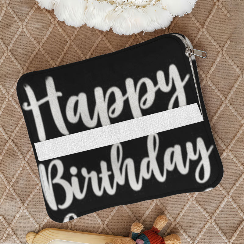 Foldable black cushion with white Happy Birthday text.