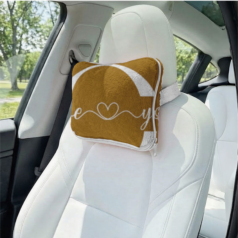 Brown foldable pillow with "love" heart on car headrest