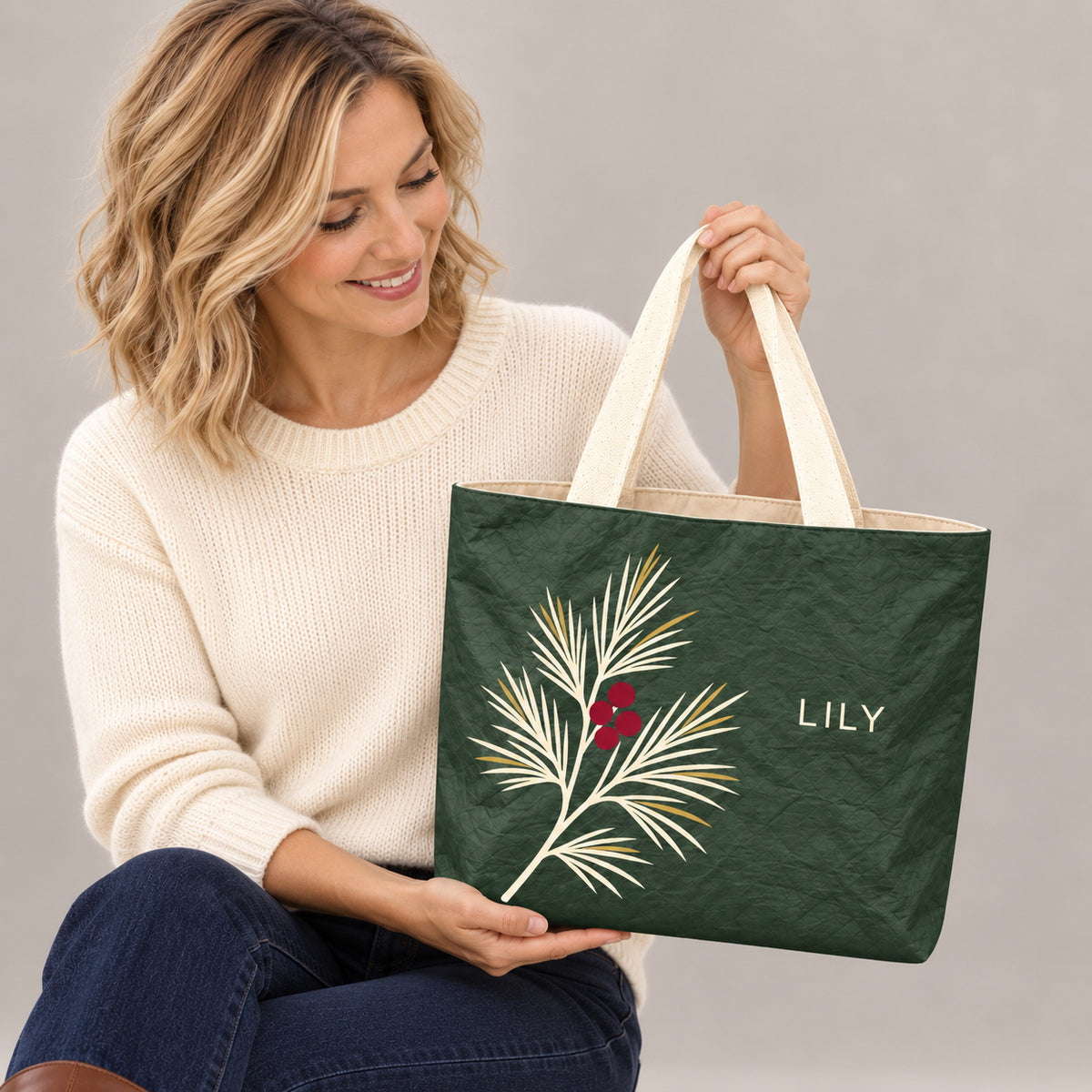 Personalized Forest Green Pine and Berry Tote Bag with Custom Name showing the custom name and botanical design detail
