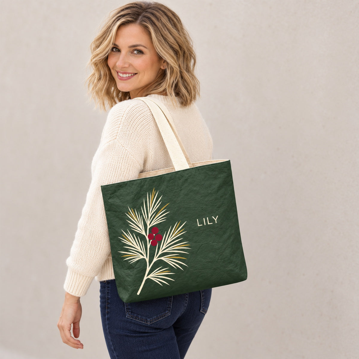 Personalized Forest Green Pine and Berry Tote Bag with Custom Name shown as an everyday shoulder carry look