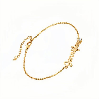 Gold plated custom name bracelet with script font. Personalized with a name & small stone.