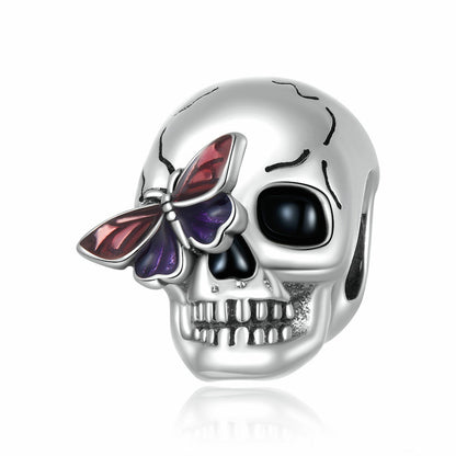 Close-up of personalized sterling silver skull charm with vibrant butterfly detail.