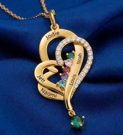 Gold name necklace resting on elegant blue silk fabric