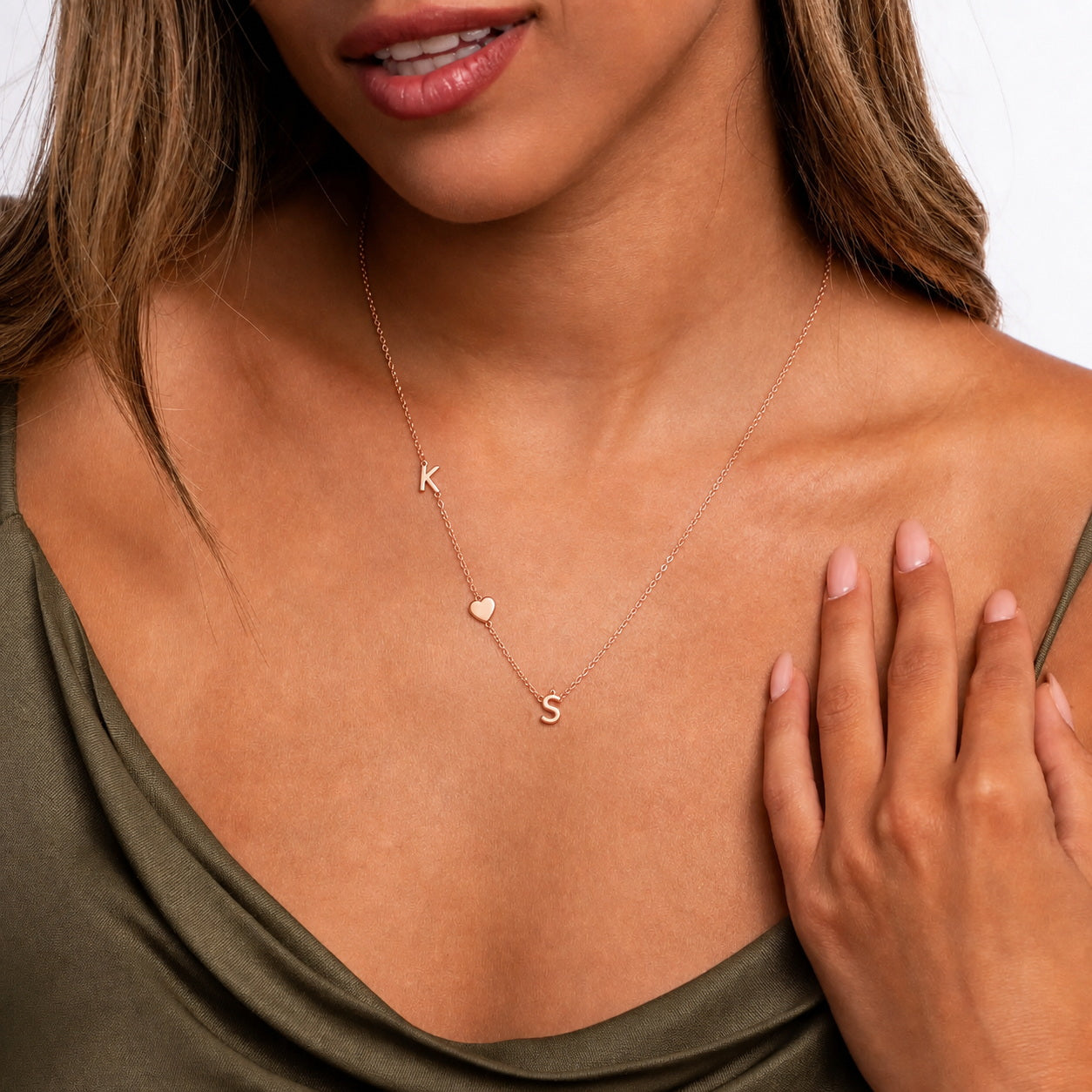 Woman wearing an initial heart necklace