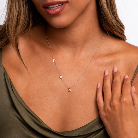 Woman wearing an initial heart necklace
