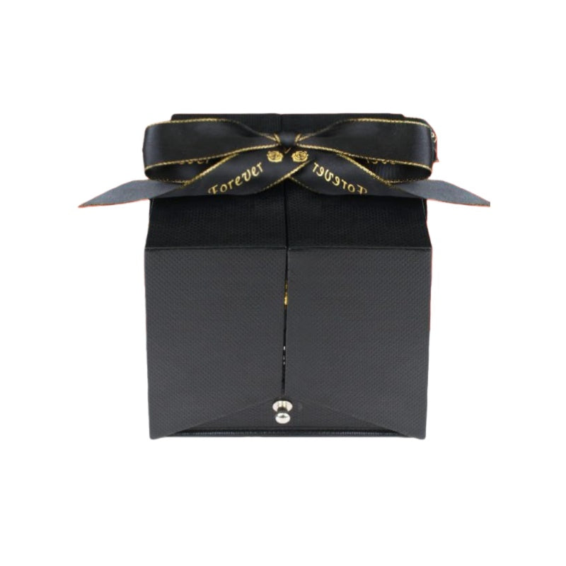 Closed luxury black jewelry box tied with a gold-lettered Forever Love ribbon.