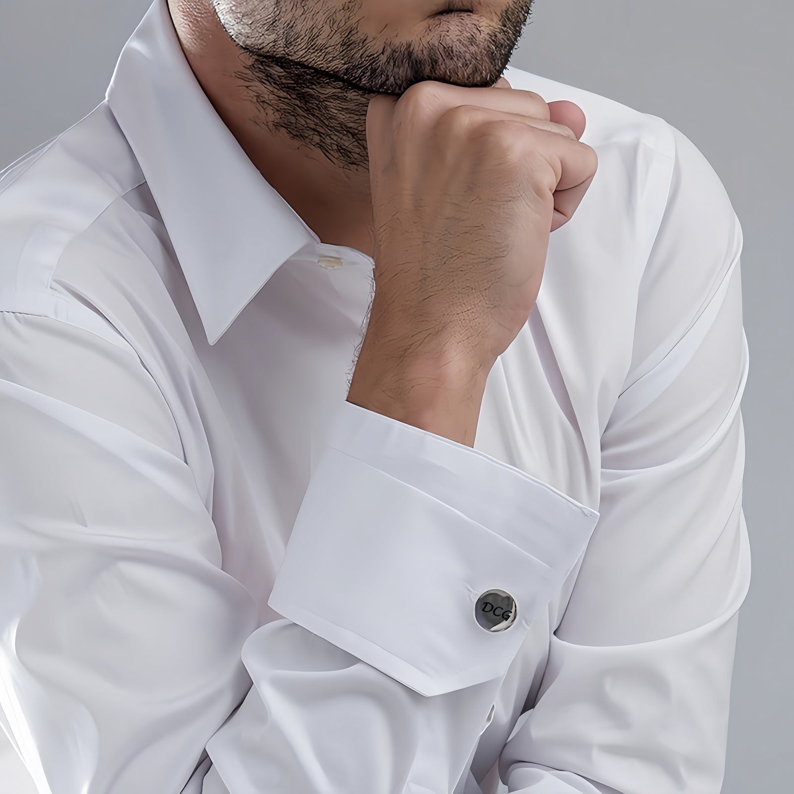 Man wearing personalized custom initial cufflinks on white shirt for business and casual style.