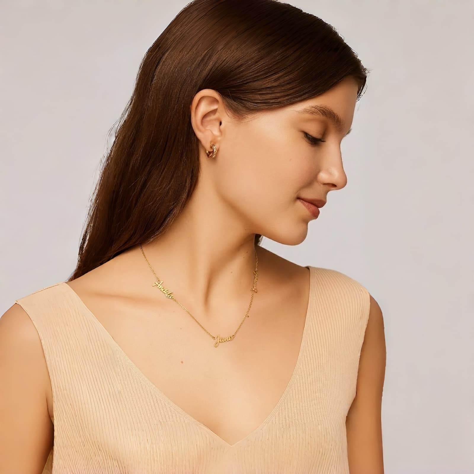 Side-profile of a model wearing a custom gold multiple name necklace, showcasing the personalized family name necklace as a Mother's Day gift.