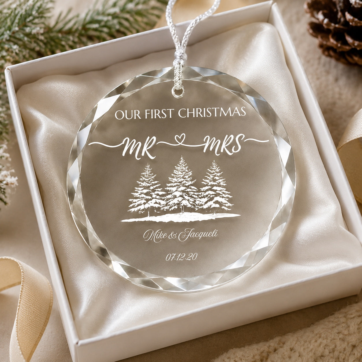 Our First Christmas Mr & Mrs Forest Design personalized glass ornament in hand scale view