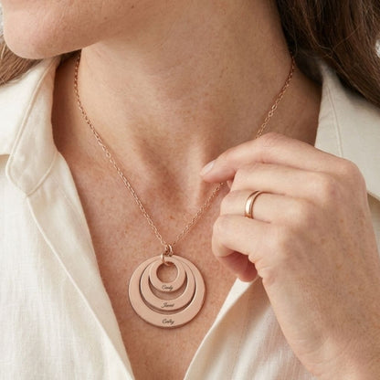 Close-up of rose gold triple disc pendant with engravings.
