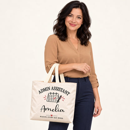 Cream Admin Assistant tote personalized with Amelia, carried on a model¡¯s forearm with the printed front visible.
