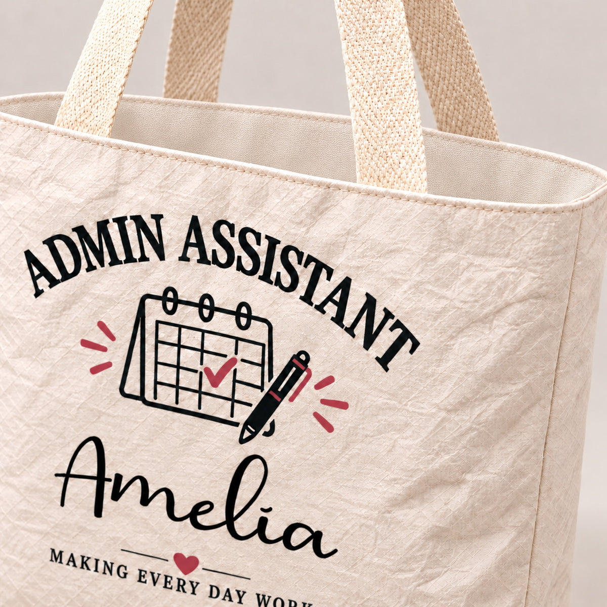 Close-up of the cream Admin Assistant tote showing its crinkled texture and woven handle.