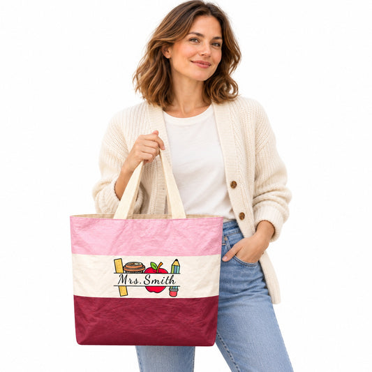 Pink, cream and burgundy teacher tote with school supplies artwork and Mrs. Smith in script on a white background.