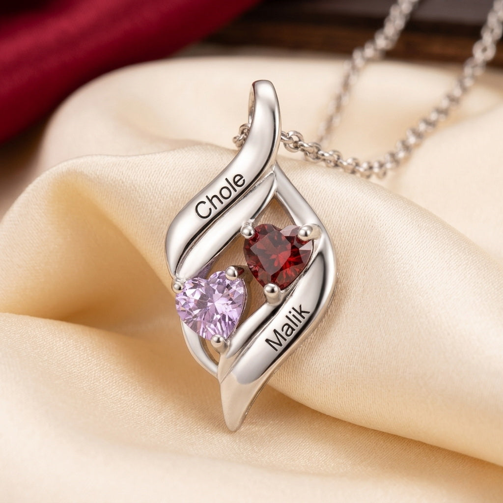 Close-up of silver heart necklace with custom names.
