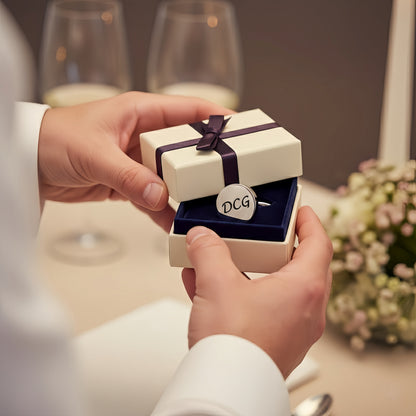 Hands opening gift box, personalized initial cufflinks for men, perfect for wedding gift.