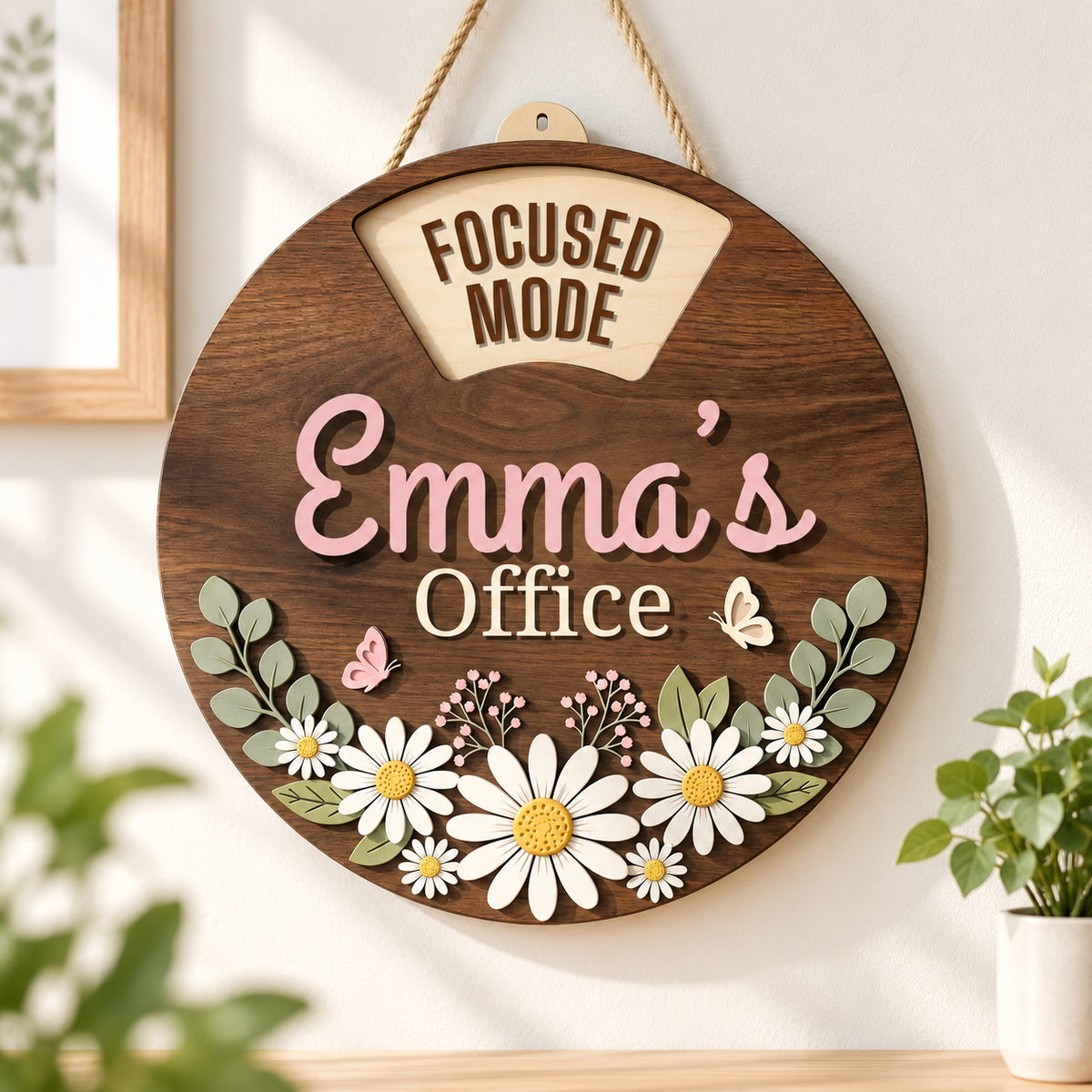 Personalized daisy office sign with Emma?s name hanging beside a bright workspace