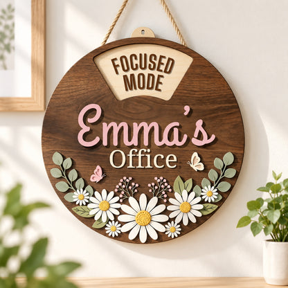 Personalized daisy office sign with Emma?s name hanging beside a bright workspace