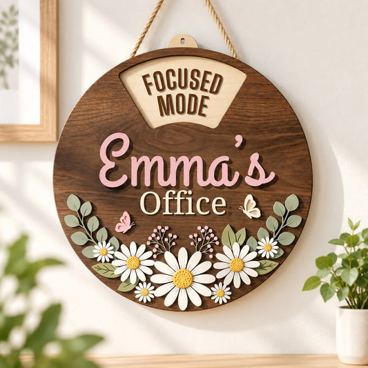 Personalized daisy office sign with Emma?s name hanging beside a bright workspace