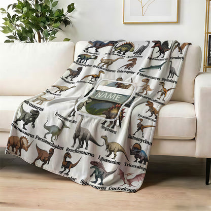 Custom dinosaur encyclopedia blanket on a white sofa.