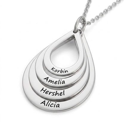 Silver teardrop pendant engraved with four family names.