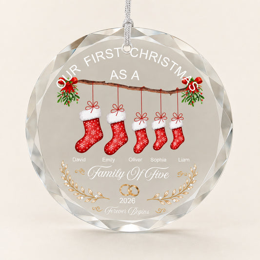 Personalized family Christmas ornament with five stockings, names, and year displayed on a clear round keepsake
