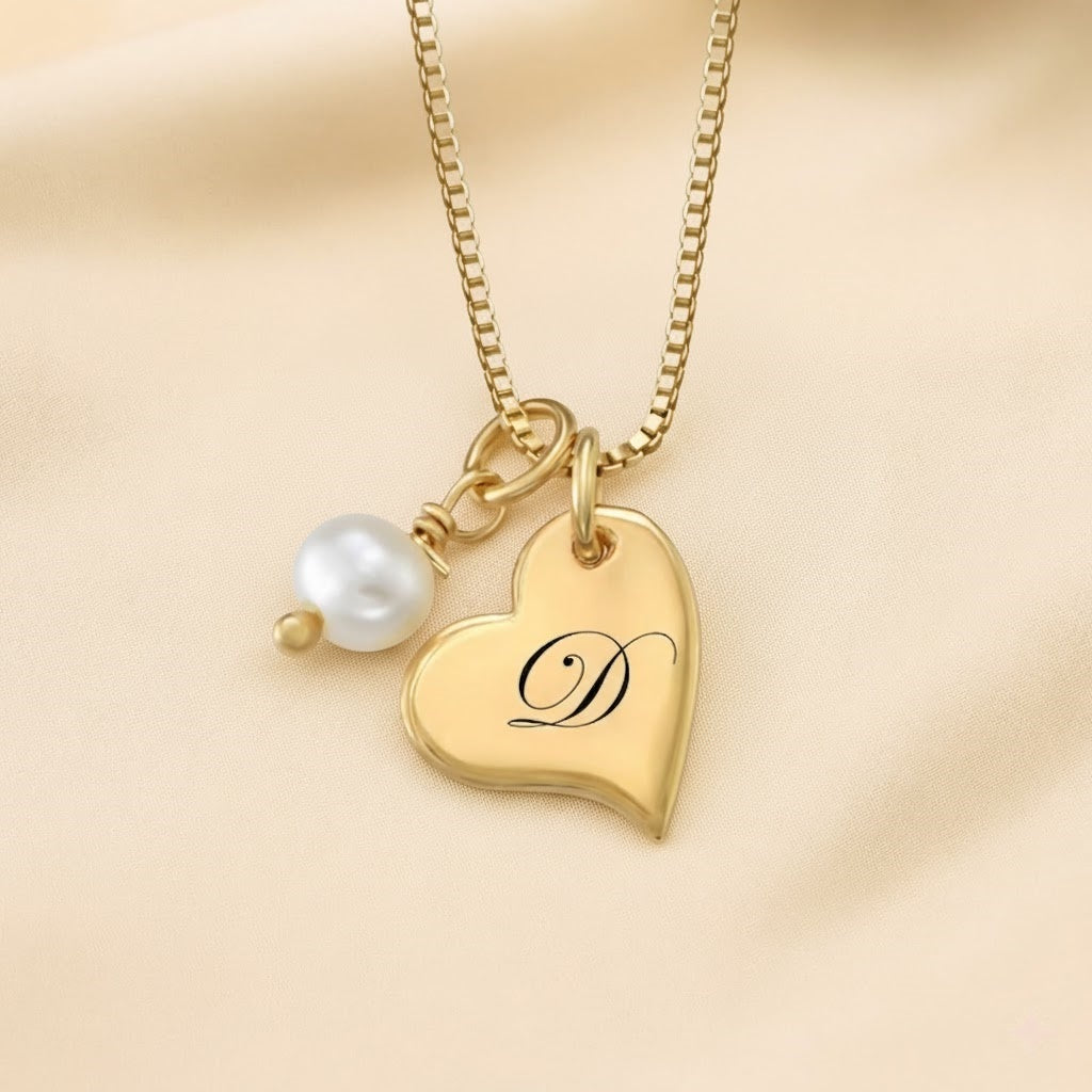 Detailed close-up shot of a personalized gold heart initial necklace with a pearl pendant.