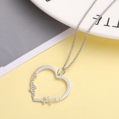Personalized heart necklace flat lay. Sterling silver custom names.