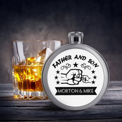 Custom personalized flask for liquor next to a glass of whiskey. Portable wine pot.