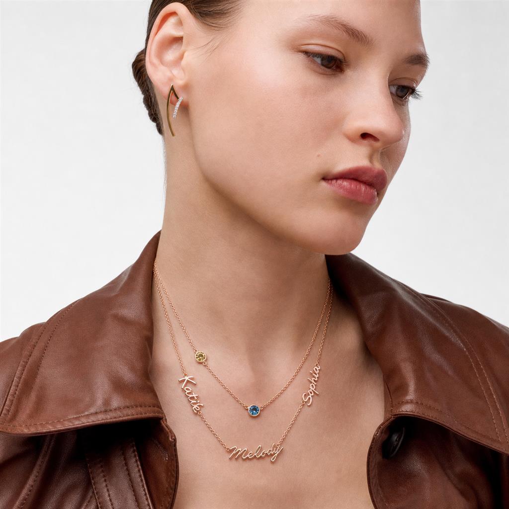 Woman wearing a layered name necklace