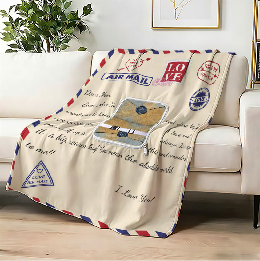 Air mail style love letter blanket on a white sofa. 