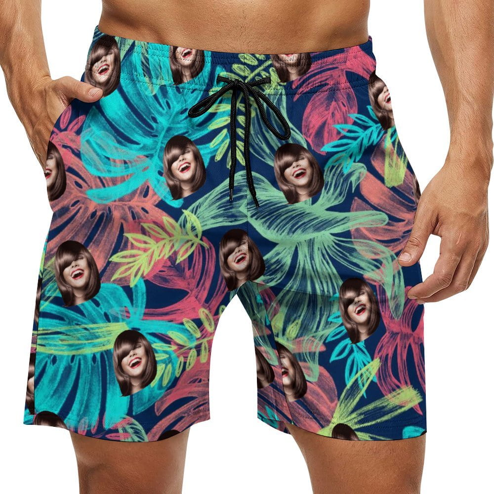 Personalized men's swim trunks with funny face print. Tropical floral beach shorts.
