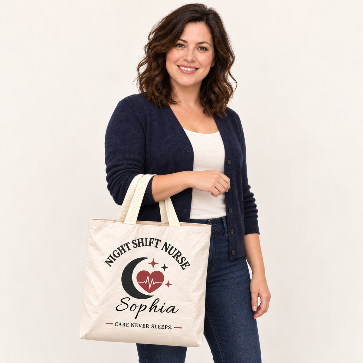 Cream Night Shift Nurse tote personalized with Sophia, carried on a model¡¯s forearm with the printed front visible.