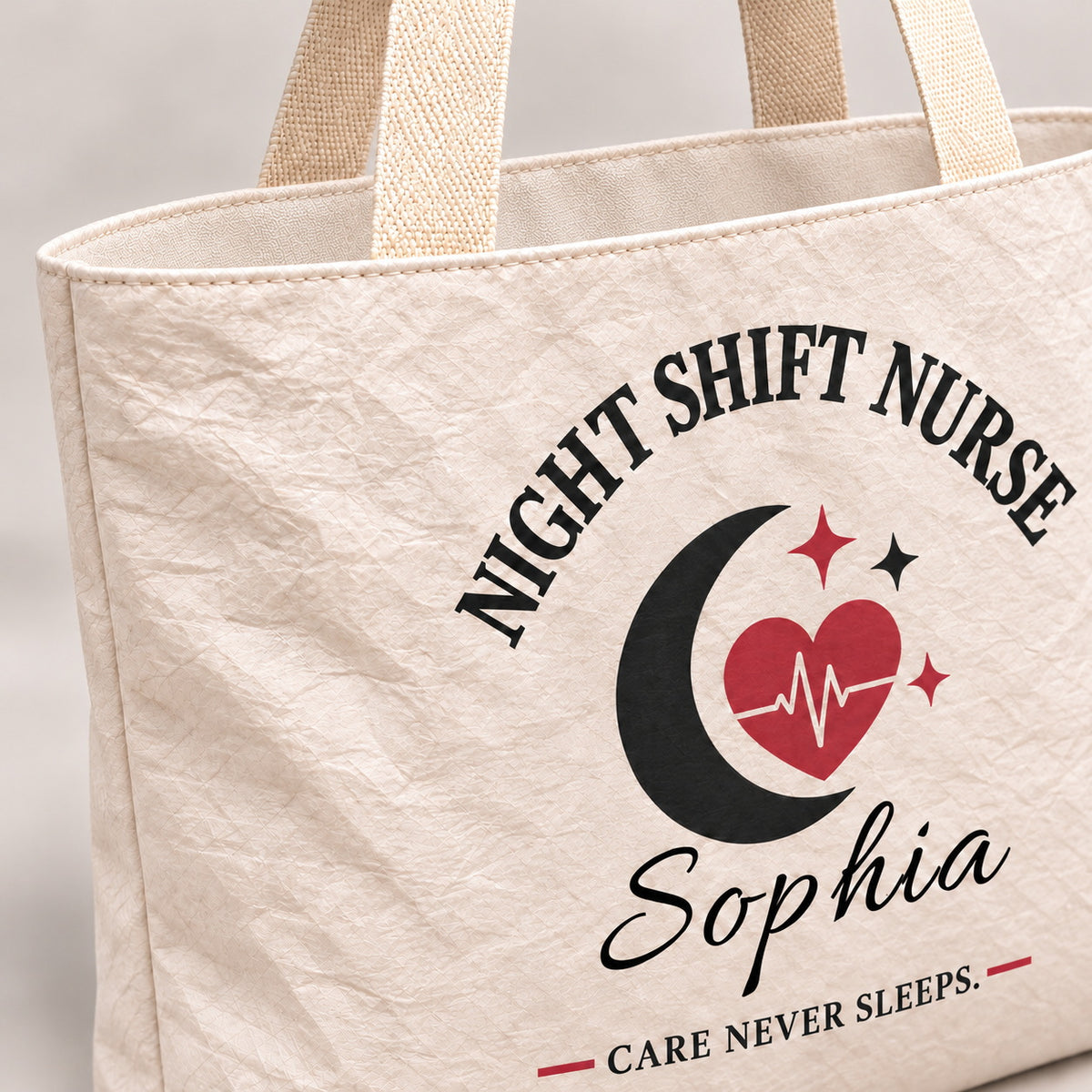 Close-up of the cream Night Shift Nurse tote showing its crinkled texture and woven handle.