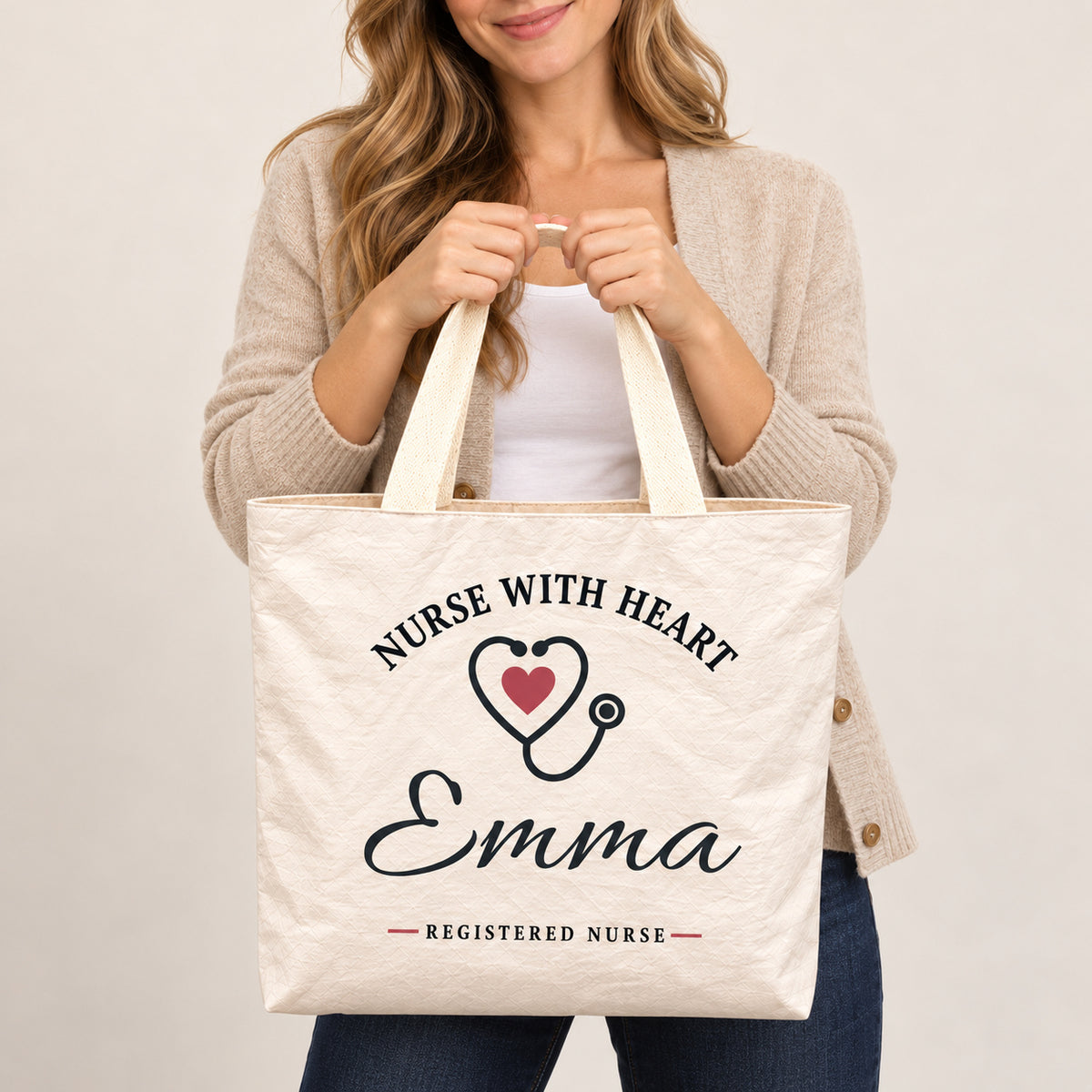 Cream Nurse With Heart tote personalized with Emma, shown close up with the custom name and printed artwork visible.