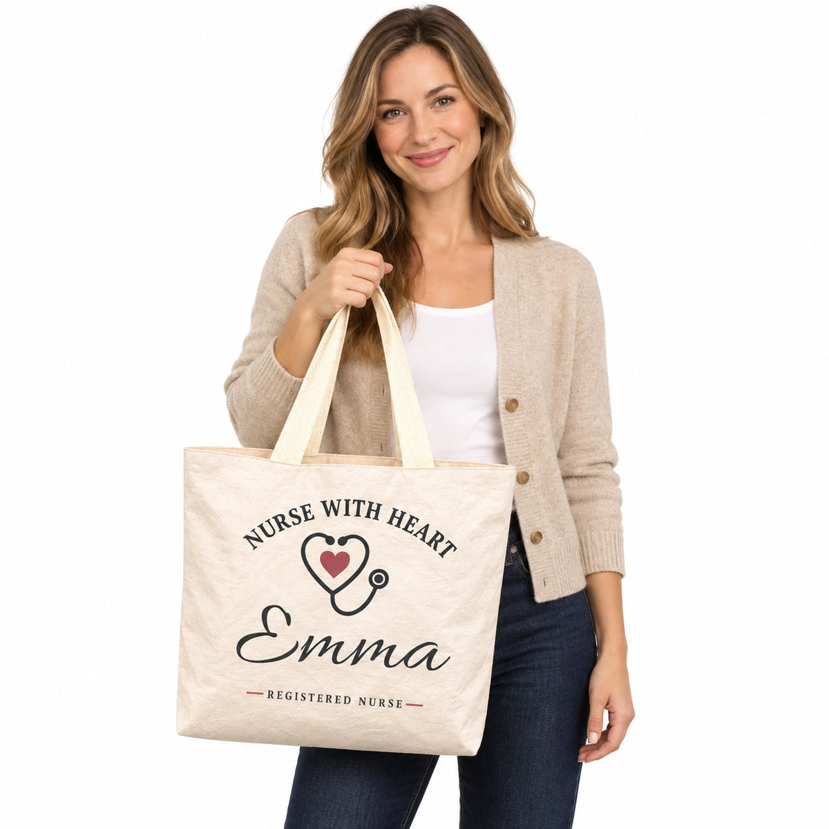 Cream Nurse With Heart tote personalized with Emma, displayed by a model against a white background.
