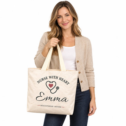 Cream Nurse With Heart tote personalized with Emma, displayed by a model against a white background.