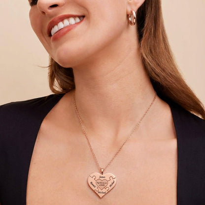 Woman wearing a rose gold family puzzle heart necklace.