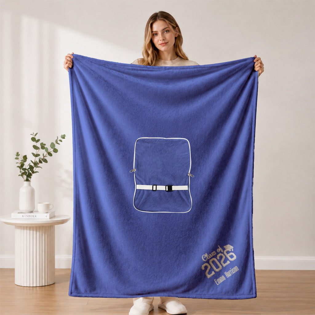 Woman holding open royal blue custom graduation blanket with embroidery name and school.