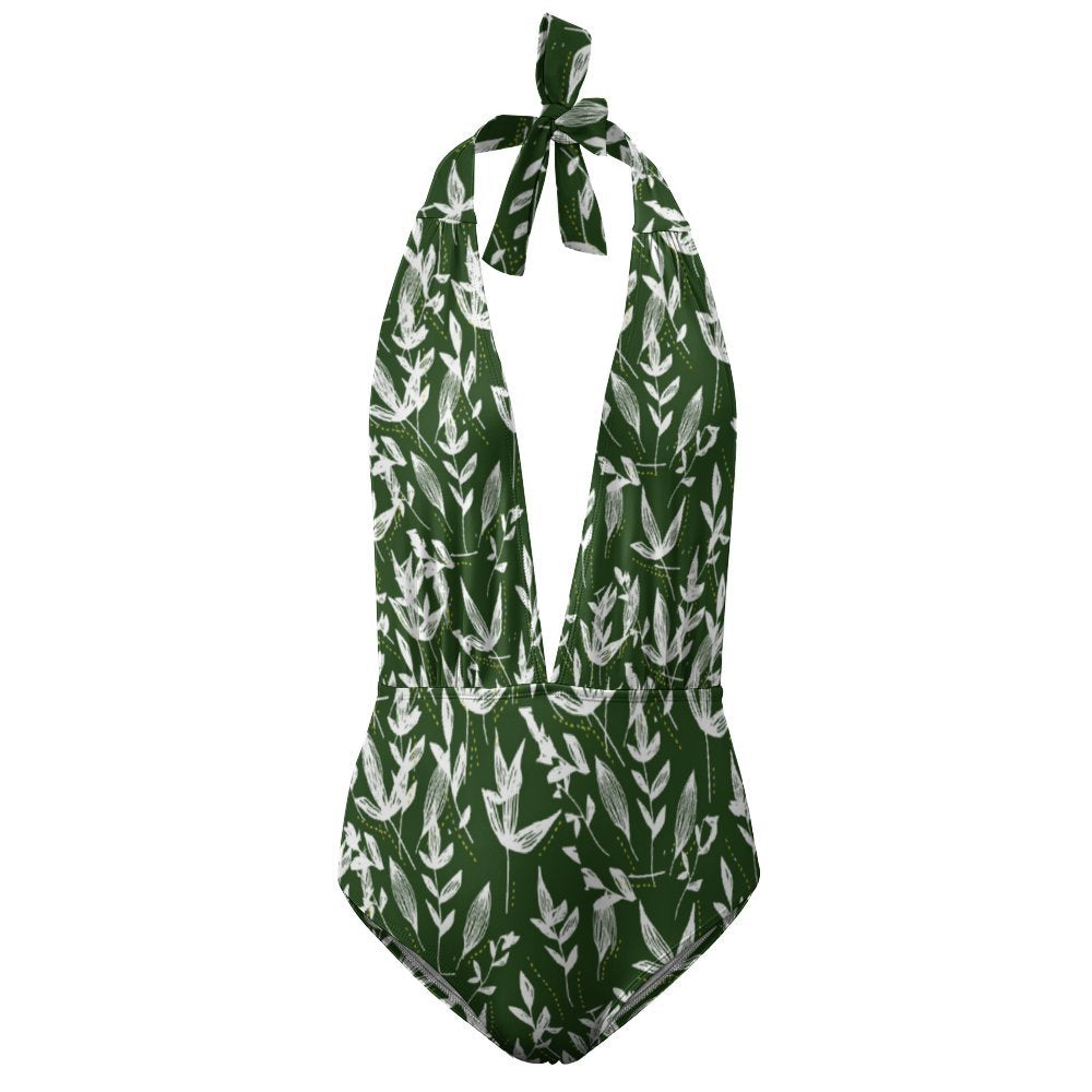Custom women's deep V neck one piece bathing suit, leaf print flat lay.