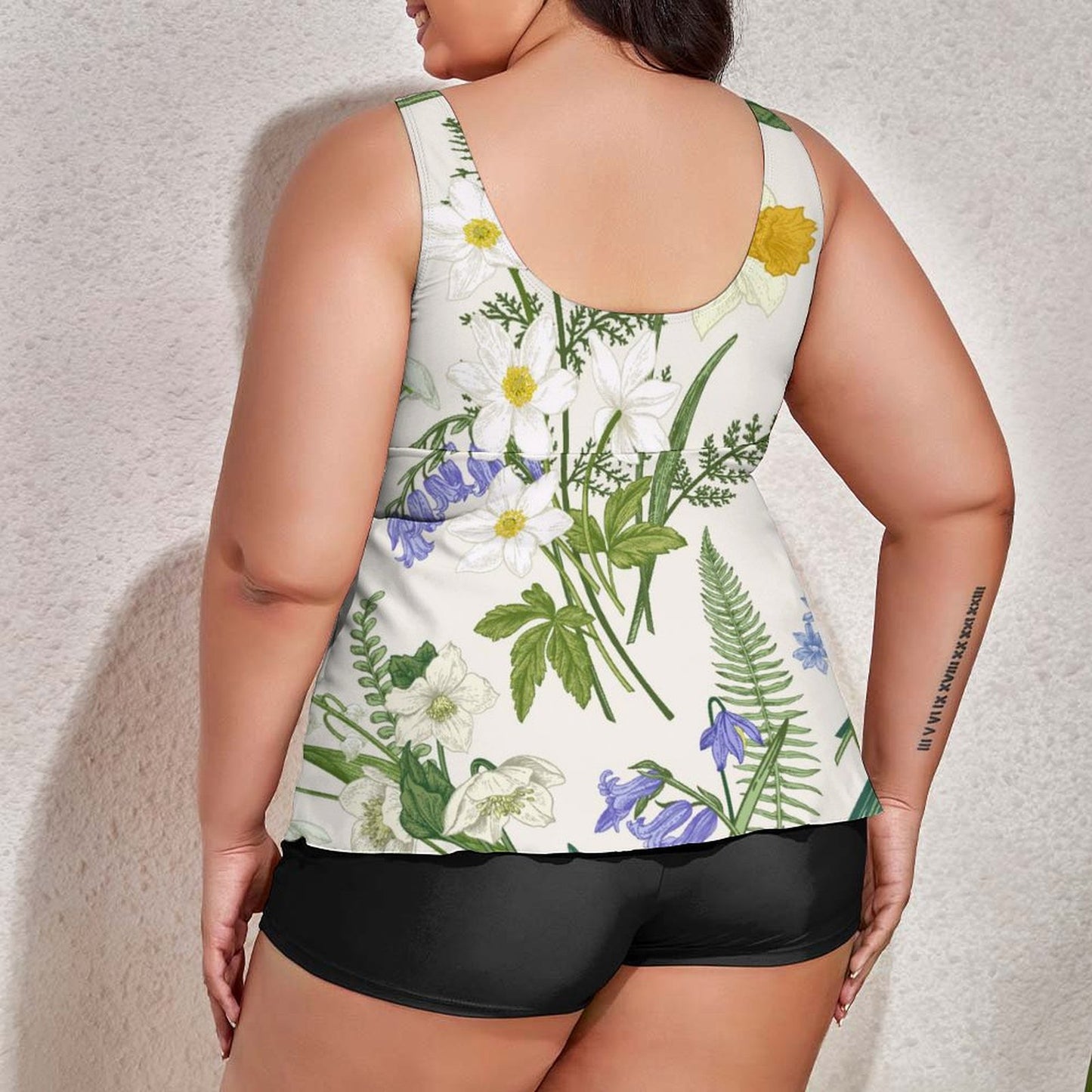 Back view of plus size flowy swimdress and black swimsuit with shorts.