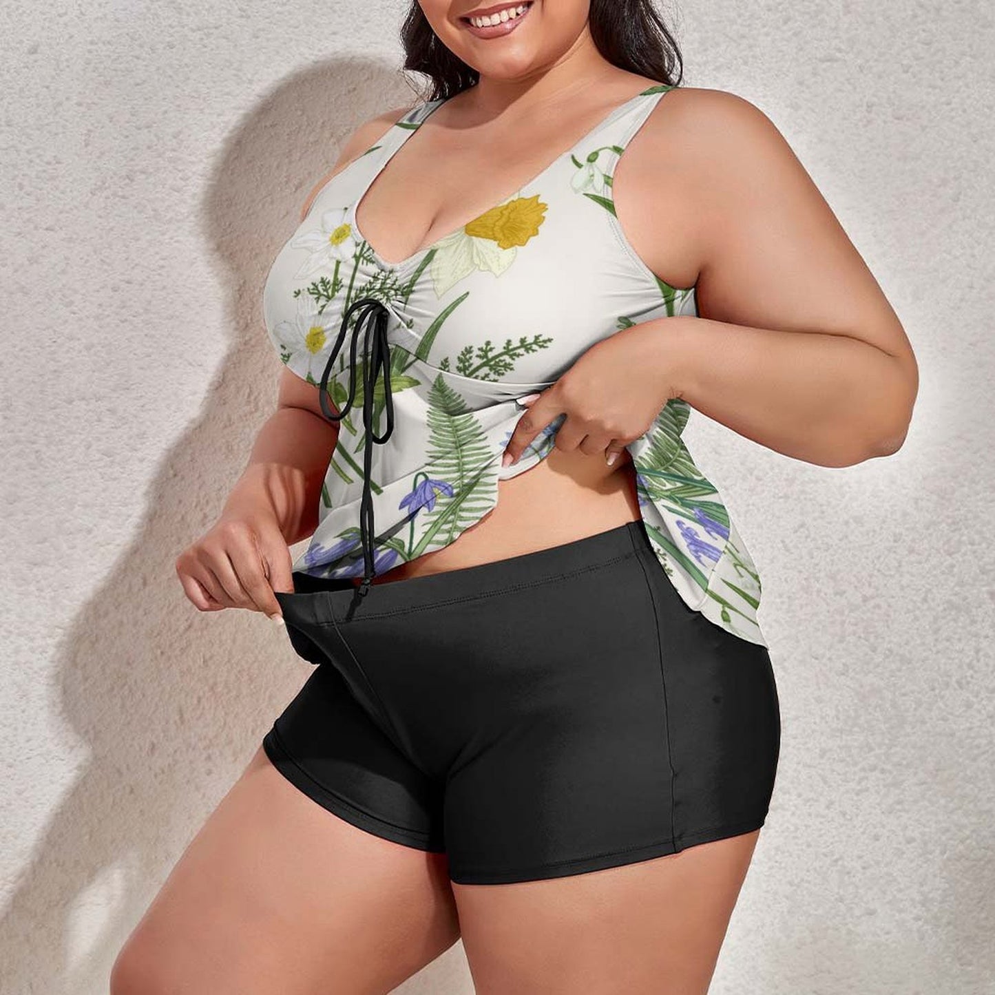 Plus size model testing stretch of swimsuit with shorts for comfort and fit.