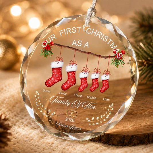 Close-up of a personalized family Christmas ornament showing clear faceted edges, printed stocking design, and festive details