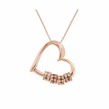Rose gold plated personalized heart necklace featuring four engraved stacking name beads.