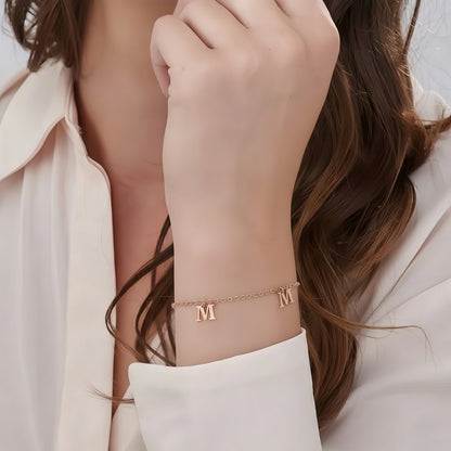 Model wearing Rose Gold Personalized Initial Bracelet, unique custom letter jewelry gift.