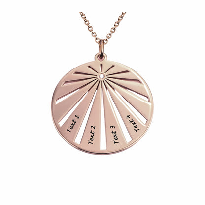Rose gold personalized circular family pendant, featuring a sunburst design and four custom text engravings.