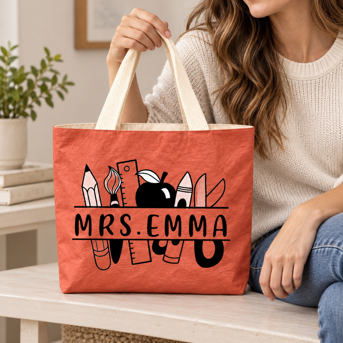 Personalized teacher tote with school supplies artwork and custom name MRS.EMMA, custom name detail view.