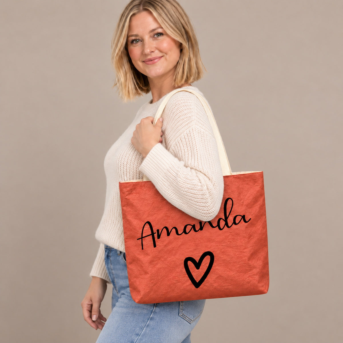 Personalized teacher tote with script name and bold heart design and custom name Amanda, shoulder side view view.