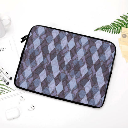 Shockproof Notebook Case with diamond pattern on a white desk with headphones.