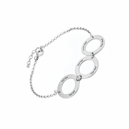 Silver interlocking circles bracelet with custom text engraving.