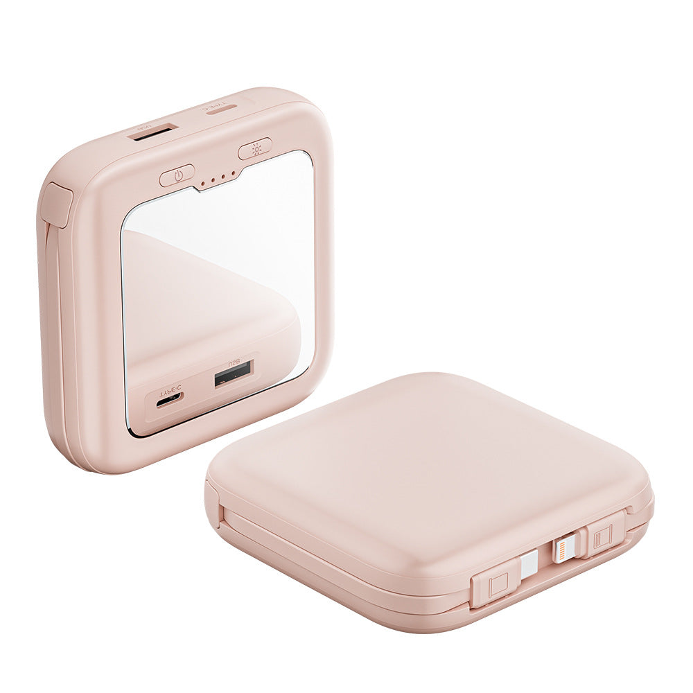 compact pink power bank with mirror and charging cables.